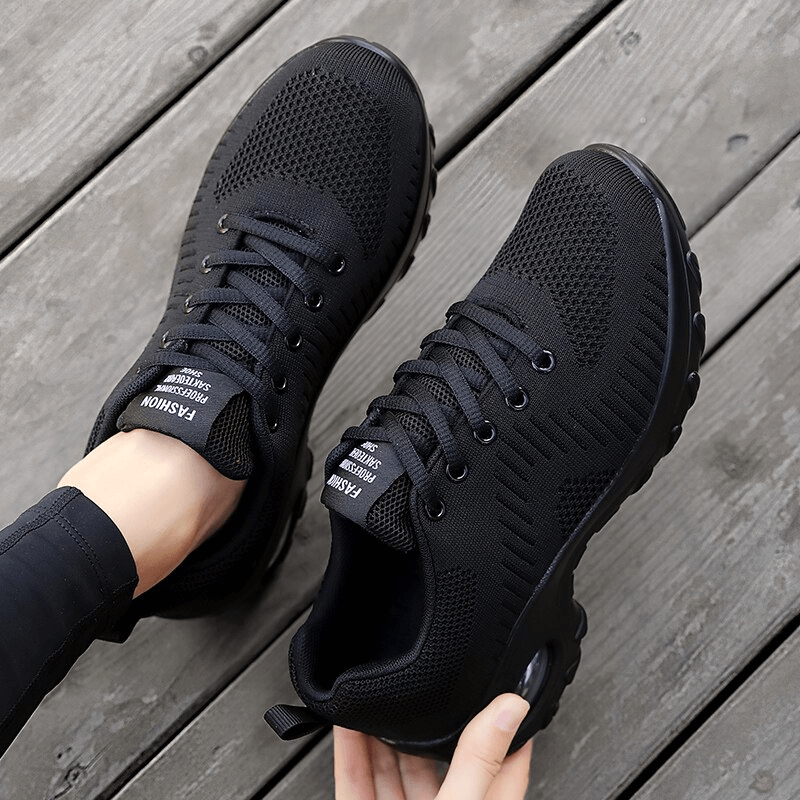 Stylish breathable black women's sneakers with mesh upper and non-slip sole, perfect for outdoor activities.